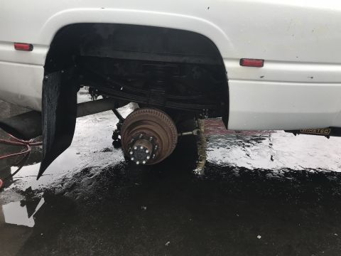 1997 Dodge 3500 - Rear suspension and axle of a 1997 Dodge 3500 truck, showing leaf springs and brake drum.