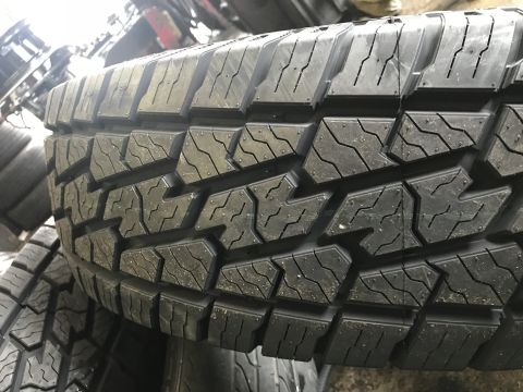 1997 Dodge 3500 - A detailed view of the aggressive tread pattern on a tire, showing its deep grooves and sipes.