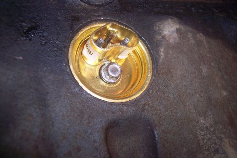 1995 Ford Bronco - Close-up of a gold-colored oil pressure sensor with a white label that reads "401N".
