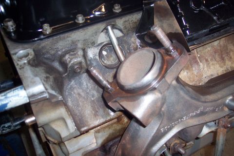 1995 Ford Bronco - Close-up view of an engine block and exhaust manifold, with visible bolts and metal components.