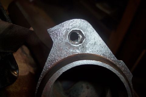 1995 Ford Bronco - A metal engine part is shown in detail, with a bolt hole visible at the top.