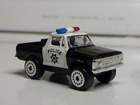 1979 Ford Bronco - This 1979 Ford F-Series pickup truck is customized as a police vehicle with a light bar and official markings.