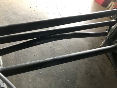 1988 Ford Bronco - Close-up view of black roll cage bars, likely part of an aftermarket safety modification.