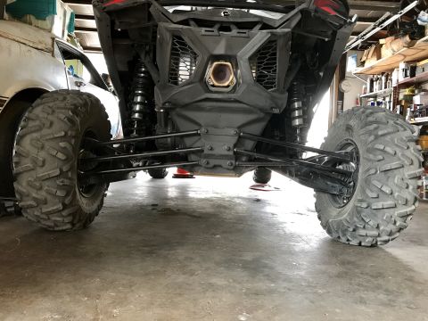 1988 Ford Bronco - Rear view of a side-by-side ATV showing its suspension and large tires.