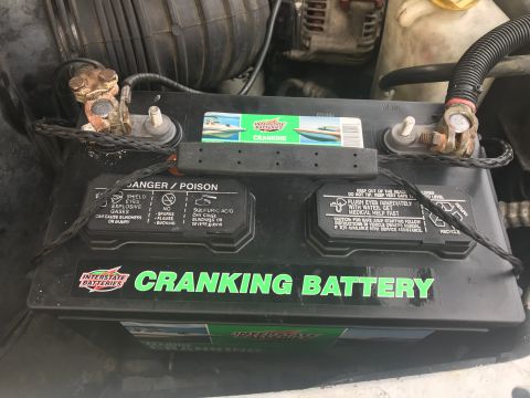 1997 Dodge 3500 - The engine bay shows an Interstate Batteries CRANKING BATTERY with visible corrosion on the terminals.