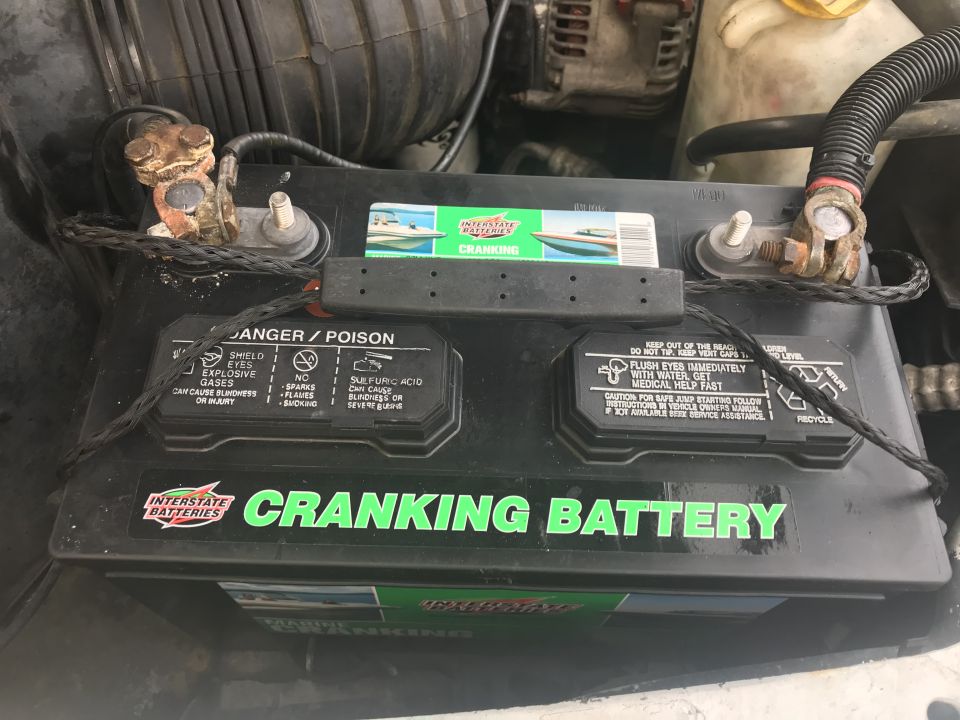 Engine bay with Interstate Batteries CRANKING BATTERY and corroded terminals