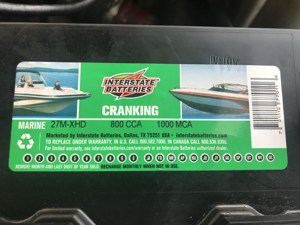 Label on a marine battery showing two speedboats and Interstate Batteries logo