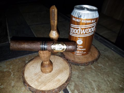 2018 Ford Bronco - A cigar rests on a wooden holder beside a can of Goodwood Walnut Brown Ale, with wooden coasters underneath.