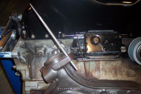 1995 Ford Bronco - Detail of an engine block, possibly during a repair or diagnostic process, with a tool inserted into a component.