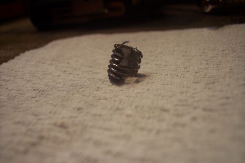 1995 Ford Bronco - A close-up view of a damaged spring, possibly from a vehicle component.