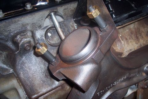 1995 Ford Bronco - Close-up of an engine exhaust manifold bolt and nut, showing engine components.