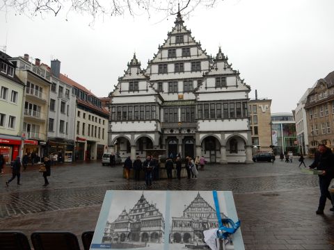 2010 Audi A4 - A town square features a distinctive stepped gable building under an overcast sky.
