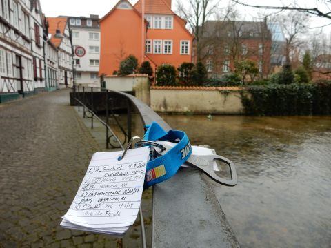 2010 Audi A4 - A keychain with a list of names and dates, along with a bottle opener, rests on a railing above a canal.