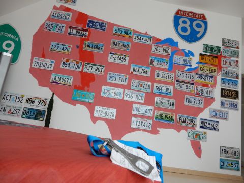 2010 Audi A4 - A wall display features a map of the United States covered in numerous license plates from different states.