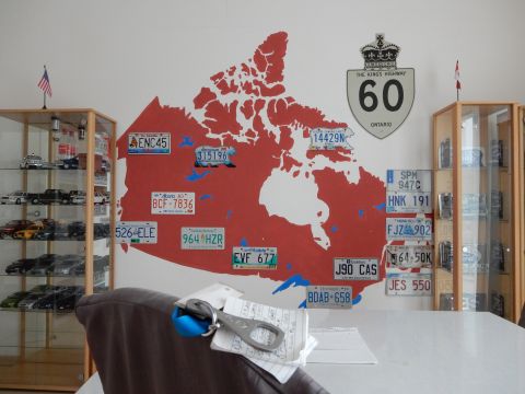 2010 Audi A4 - A room decorated with a map of Canada, license plates, and model car displays.