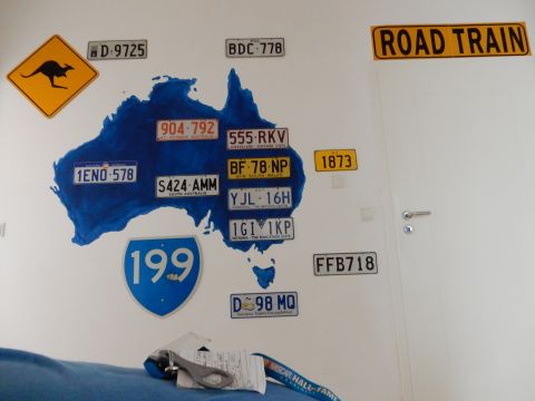 2010 Audi A4 - A wall decorated with Australian license plates and a road sign.