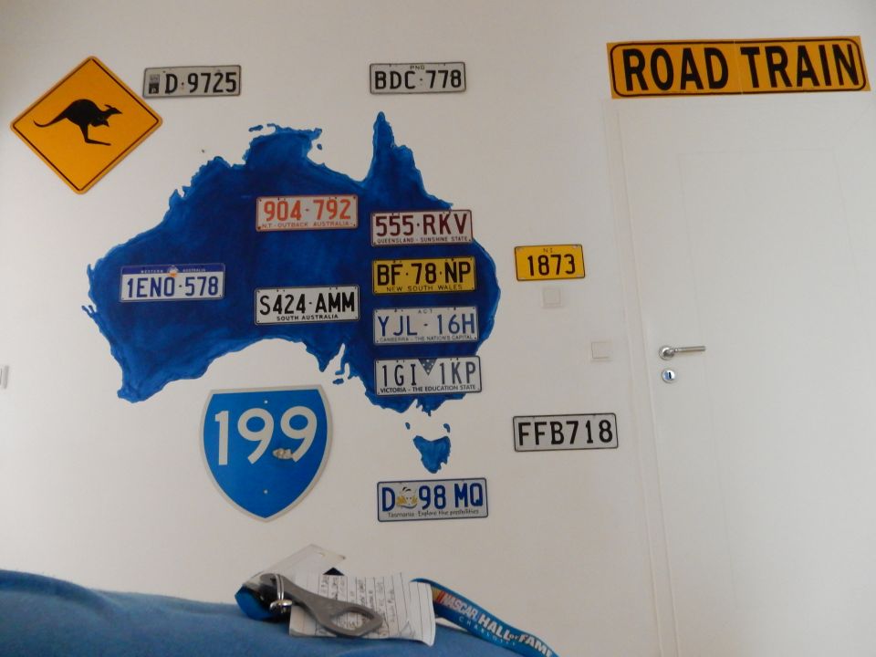 Wall art of Australia with license plates and a kangaroo crossing sign