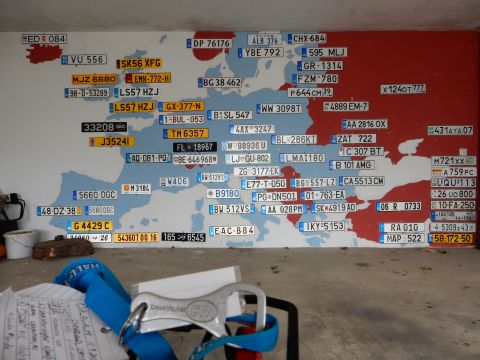 2010 Audi A4 - A wall decorated with a map of Europe, with various license plates affixed to represent different countries.