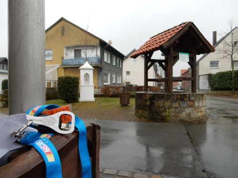 2010 Audi A4 - A street scene shows a well and houses under an overcast sky, with a pole and accessories in the foreground.