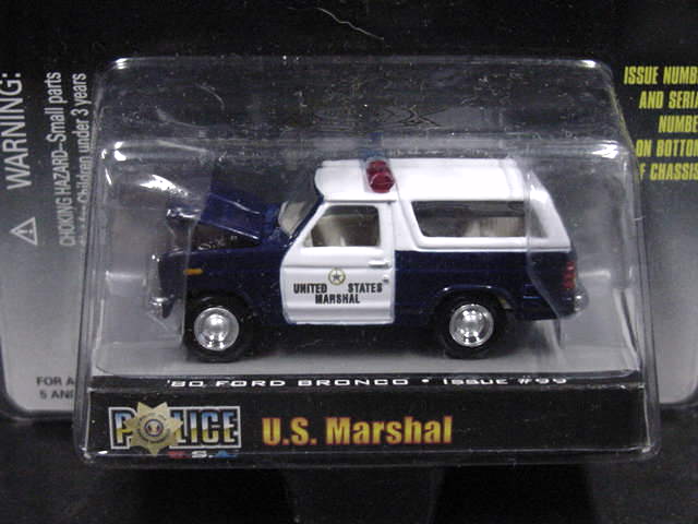 Toy 1980 Ford Bronco police car with 'United States Marshal' text on the side, in packaging