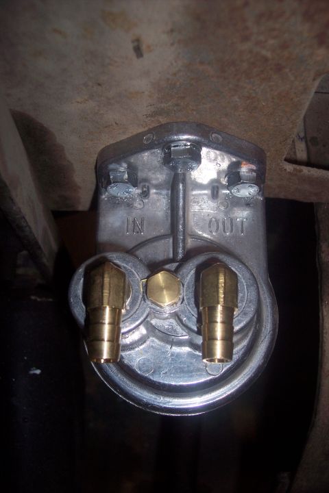 1995 Ford Bronco - Fuel filter with IN and OUT ports, brass fittings, and mounting hardware visible.