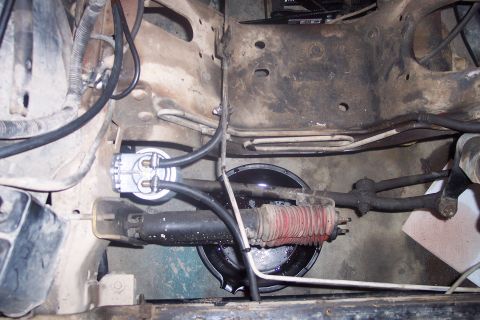 1995 Ford Bronco - Close-up of engine bay components including fuel filter, shock, and steering linkage.