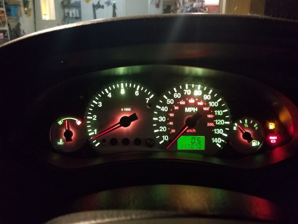 Illuminated instrument cluster with speedometer, tach and odometer reading 117070