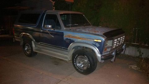 1996 Ford Bronco - This Ford Bronco is parked outside at night, showing its front quarter view.