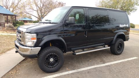 1996 Ford Bronco - This black Ford van has been modified with larger tires and a lifted suspension for off-road use.