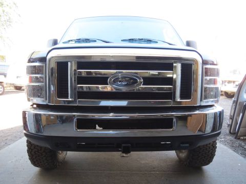 1996 Ford Bronco - Front view of a Ford Super Duty truck grille, showing chrome detailing and the Ford emblem.