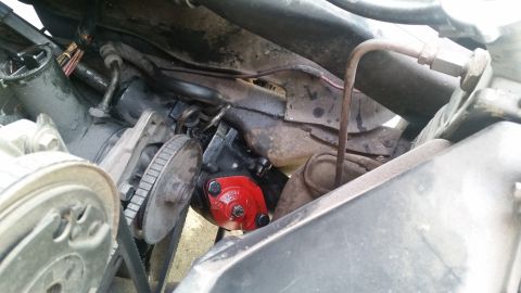 1985 Ford Bronco - Close-up view of engine components including the power steering pump and associated hardware.