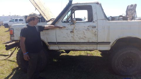 1988 Ford Bronco - Muddy 1988 Ford Bronco with snorkel and open hood, a person is standing next to it.