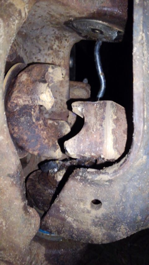 1988 Ford Bronco - Close-up view of heavily corroded and broken suspension components, with a watermark for Supermotors.net visible.