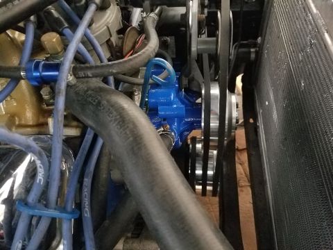 1976 Ford Ranchero - Close-up view of an engine bay, highlighting a bright blue water pump and associated belts and hoses.