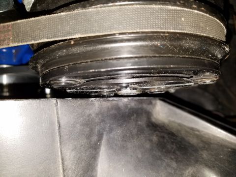 1976 Ford Ranchero - Detail of a belt and pulley system, likely part of an engine's accessory drive.