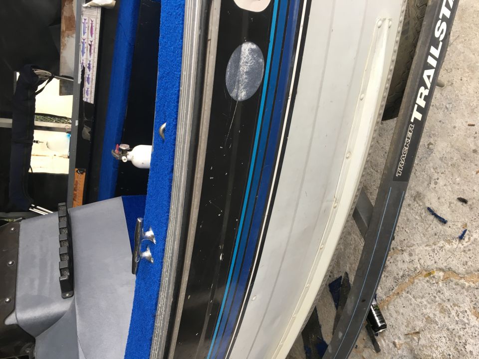 Boat interior with blue carpet and white fire extinguisher