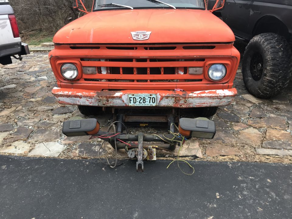 Orange 1961 Ford F-350 front view with snow plow attachment and Maryland license plate FD:28:70
