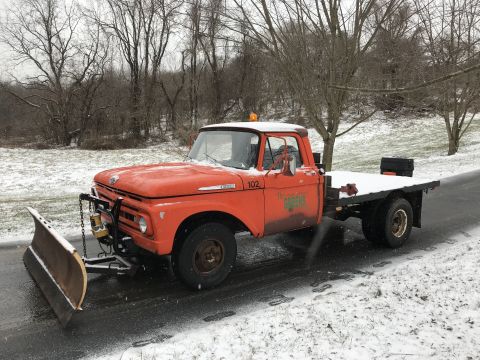 1961 Ford F-350 - This truck appears to be a Ford F-series from the early 1960s, equipped with a snow plow and flatbed.