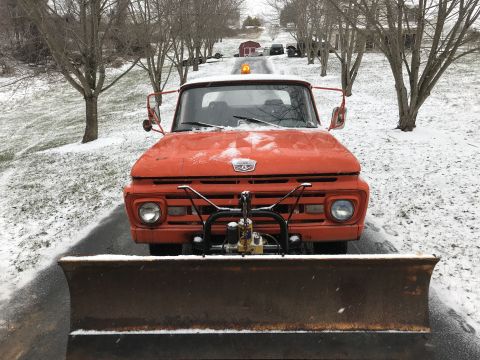 1961 Ford F-350 - This 1961 Ford F-350 is equipped with a snow plow and parked on a snow-covered driveway.