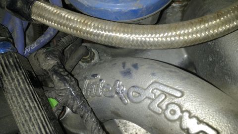 1996 Ford Bronco - A metal engine part with 'Trick Flow' branding is visible in this close-up view.