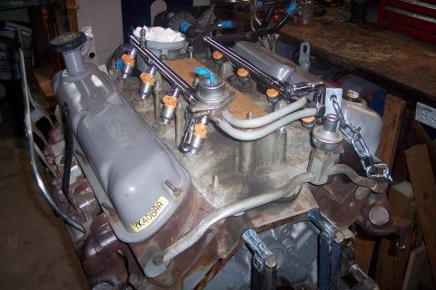 1995 Ford Bronco - A Ford V8 engine is shown with fuel injectors and valve covers, with a visible part number.