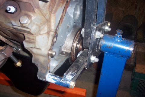 1995 Ford Bronco - Engine block detail with a belt and pulley system, mounted on a stand for repair or maintenance.