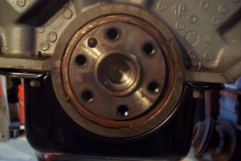 1995 Ford Bronco - Close-up of an engine's crankshaft seal and oil pan, with part number '1P' visible.