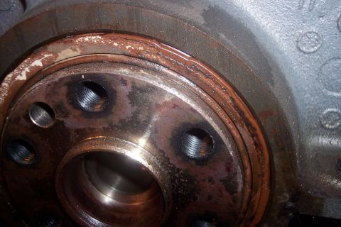 1995 Ford Bronco - This image shows a close-up of a worn engine crankshaft seal, indicating a need for replacement.