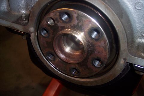 1995 Ford Bronco - Close-up view of the engine's crankshaft seal area, showing bolt holes and wear.