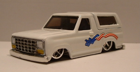 1979 Ford Bronco - white die-cast Ford Bronco model dropped low on chrome wheels with a stars-and-stripes graphic along the body.