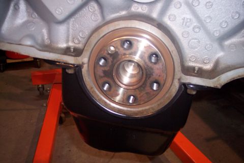 1995 Ford Bronco - Close-up of an engine's crankshaft seal area, mounted on an engine stand.
