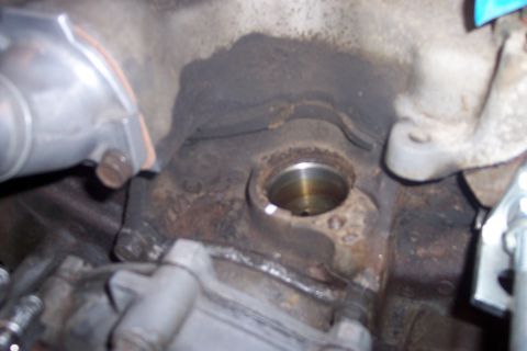 1995 Ford Bronco - Engine block detail with visible oil residue in a circular opening.