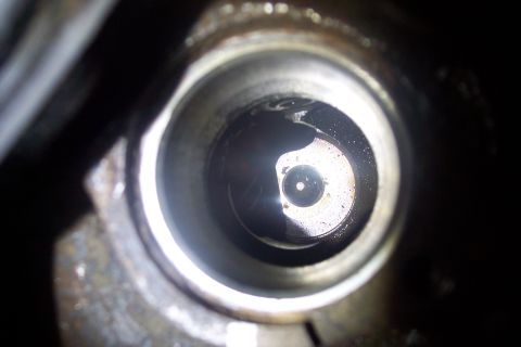 1995 Ford Bronco - Looking into a spark plug hole, likely from an engine.