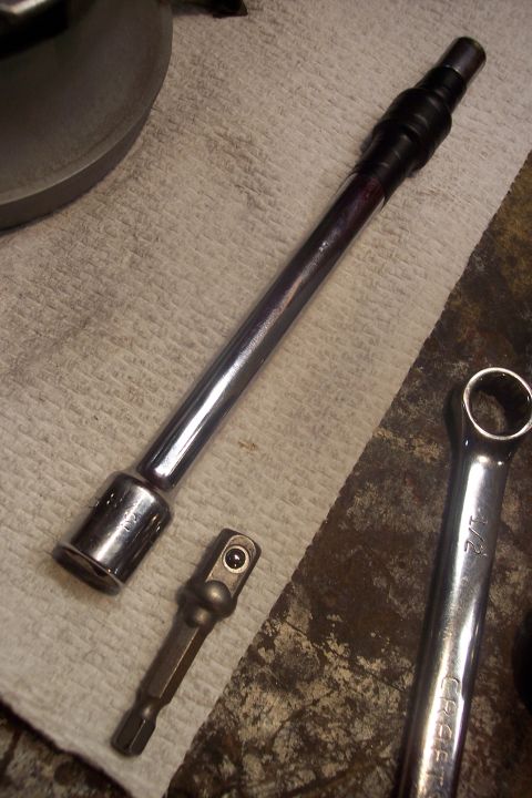 1995 Ford Bronco - Tools laid out on a rag, including a socket extension, adapter, and a 7/16 inch wrench.